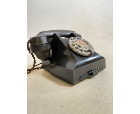 A vintage black telephone with drawer to the base.