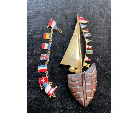 An unusual brass and enamel decorated brooch set with flags, length 95mm, and a pin link set with enamel flags (2).