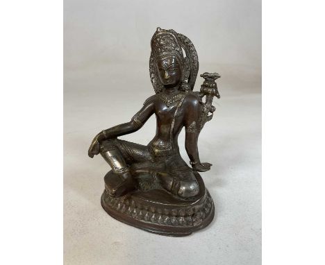 A 19th century Sino-Tibetan bronze figure of a seated male, height 16.5cm.