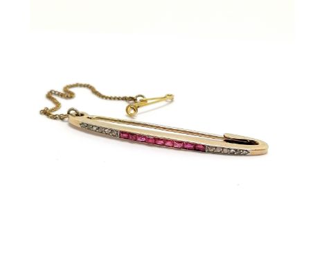 Foreign marked 15ct gold ruby &amp; diamond set Art Deco bar brooch (4.5cm) with a safety chain - total weight 3g in a James 