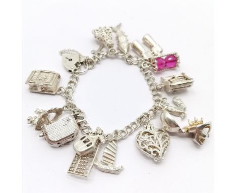 Silver charm bracelet with charms inc abacus, toaster, Chim 2 cats in boat at sea, skull opening to reveal witches head etc -