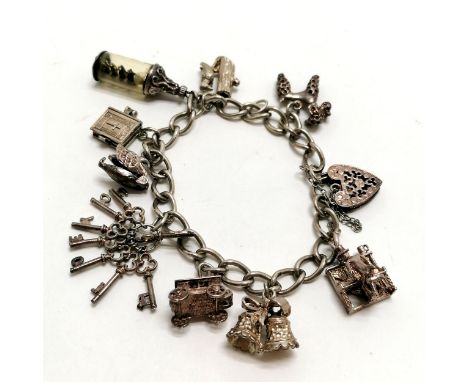 Silver charm bracelet with charms inc Nuvo bible, swan revealing ballerina, woodpecker on tree trunk etc - 44g total weight 
