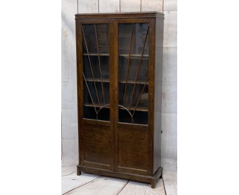 VINTAGE OAK TWO DOOR BOOKCASE with sunburst effect beading to the glass, with interior adjustable shelving, 175cms H, 87cms W