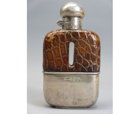 SILVER MOUNTED HIP FLASK - Sheffield 1906, maker H Greaves Ltd having a hinged twist cap to a glass bottle, the top half in c