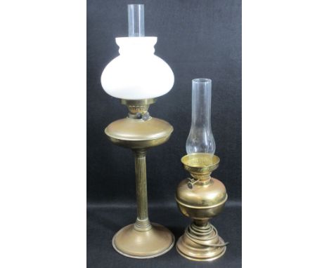 TWO BRASS BASED VINTAGE OIL LAMPS, the smaller converted for electricity, 70cms H the tallest