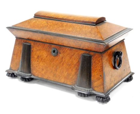 A Regency burr walnut and rosewood sarcophagus tea caddy, the hinged lid opening to reveal two lidded tea canisters, flanking