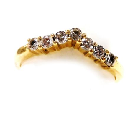An 18ct gold and seven stone diamond wishbone eternity ring, approx ⅓?ct, size N/O, 3.2g. 