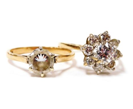 A 9ct gold and cubic zirconia solitaire ring, size Q, together with a 9ct gold and cubic zirconia nine stone flower head ring