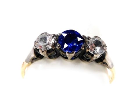 A blue and white sapphire three stone ring, high claw set in yellow metal, stamped 18ct, size O, 2.2g. 