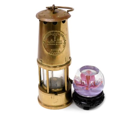 A Protector Lamp and Lighting Company type six brass miner's lamp, 23cm high, a Caithness Madrigal paperweight, and an Orient