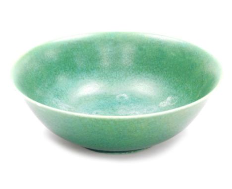 A Pilkington Royal Lancastrian pottery bowl, in a mottled green glaze, impressed marks and numbered 2524, 23cm diameter. 