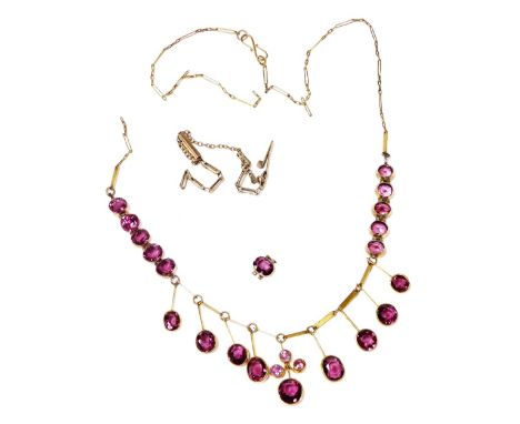 An early 20thC amethyst fringe necklace, on a fancy link neck chain, 45cm wide, together with a further loose amethyst and a 