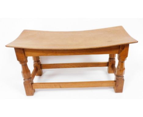 A Robert Thompson Mouseman oak double dish topped stool, on octagonal supports with carved mouse to one leg, united by stretc