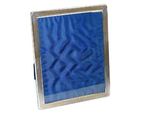 An Elizabeth II silver mounted photograph frame, of rectangular form with engine turned decoration and strut support, Sheffie