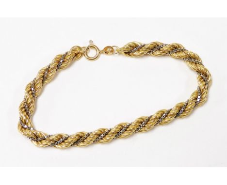 An 18ct two colour gold rope and chain link bracelet, on a bolt ring clasp, 12.2g.