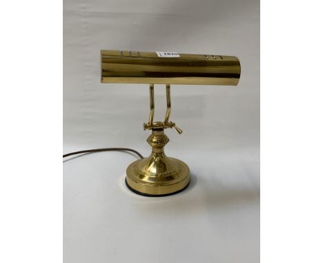 BRASS DESK LAMPraised on a circular base with adjustable arm and light shade 