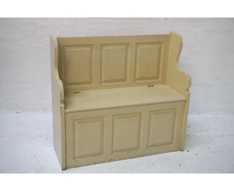 PAINTED PINE HALL BENCHwith a three panel back and shaped sides above a lift up seat with a panelled front below, 96cm wide 