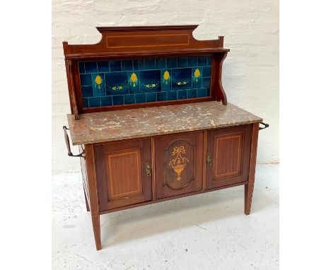 EDWARDIAN MAHOGANY AND INLAID WASHSTANDthe shaped raised back with a shelf above a deep blue tiled back with swag decoration 