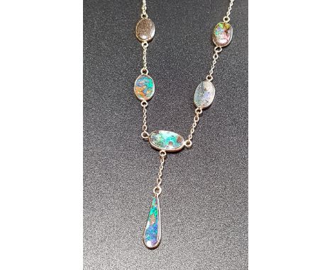 ATTRACTIVE BOULDER OPAL SET NECKLACEwith an opal drop suspended from the necklace formed with oval opals separated by chain l