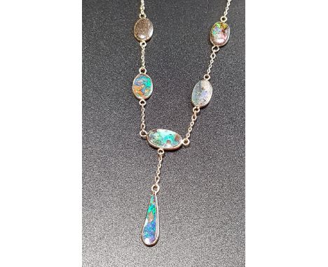 ATTRACTIVE BOULDER OPAL SET NECKLACEwith an opal drop suspended from the necklace formed with oval opals separated by chain l