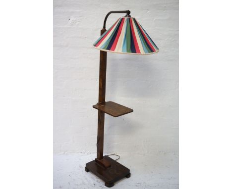 1930'S WALNUT STANDARD LAMPraised on an oblong base with a square column with a shelf, rising to a shaped metal arm with a mu