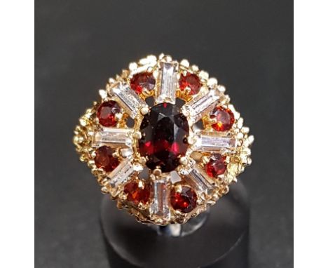 GARNET AND CZ CLUSTER COCKTAIL RINGin shaped setting and on nine carat gold shank, ring size L 