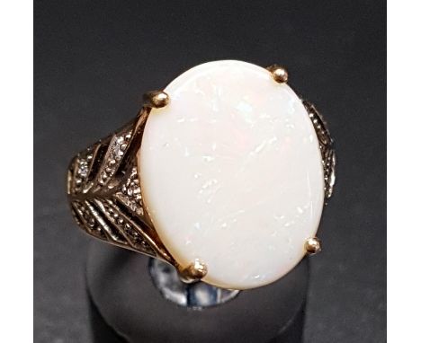 OPAL AND DIAMOND DRESS RINGthe central oval opal flanked by diamond set split shoulders, on nine carat gold shank, ring size 