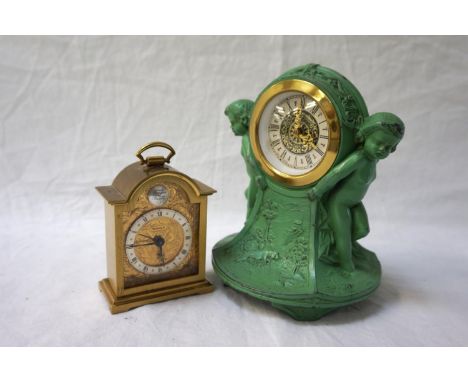 ART DECO STYLE METAL MANTLE CLOCKwith two cherubs either side of face and landscape scenes; together with a gilt Swiza carria