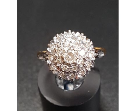 DIAMOND CLUSTER DRESS RINGon eighteen carat gold shank with stepped setting, ring size M 