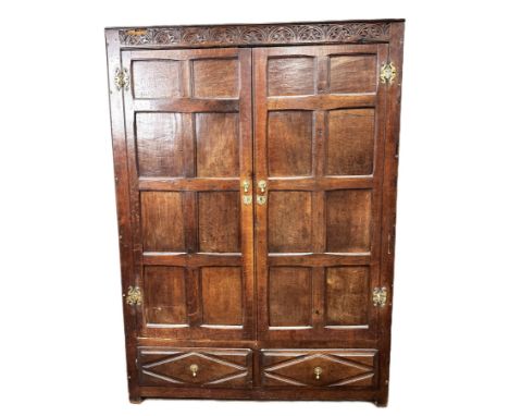 A Jacobean style oak livery cupboard, 17th/18th century and later,   with two panelled doors over two short drawers, probably