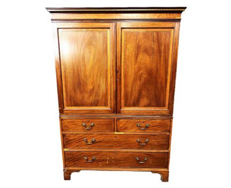 A 19th century mahogany linen press,   with a moulded and satin and ebony inlaid cornice, over two panelled and cross-banded 