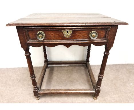 A William & Mary oak side table, late 17th century and later,  with a rectangular planked top, over a single drawer with serp
