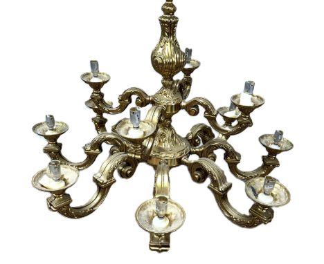 A 19th century style twelve arm gilt metal chandelier, 20th century,   with two tiers of scroll arms issuing from a central l