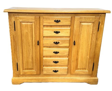 A large light oak cabinet with CD storage drawers, 126 x 154 x 46 cm.