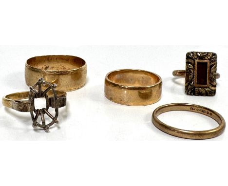 A group of four 9ct gold rings, largest size Z+3, 17.4 g gross, and another 9ct gold mourning ring, cushion mount is likely p