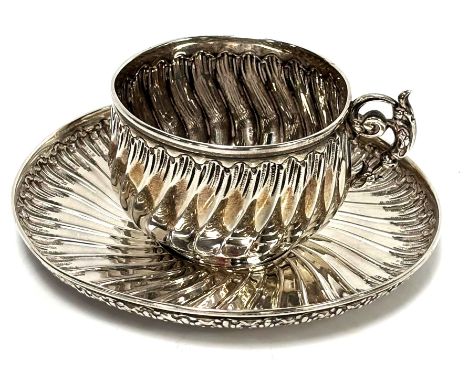 A French silver cup and saucer, hallmarked and inscribed Savard, circa 1900,   of part fluted form, 105g (gross) (2). Conditi