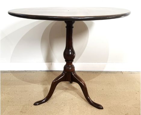 A George III mahogany snap top wine table, mid 18th century,   with a plain circular top, on a baluster turned pillar and tri