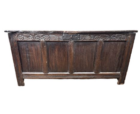 A Charles II oak coffer, circa 1670,  with a wide panelled hinged lid, the chest with panelled front and sides, including a f