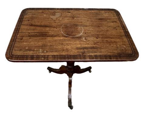 A late Regency tripod wine table, early 19th century,  with rounded oblong top, ebony line stringing and set on a turned pill