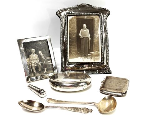 A small group of silver including two photo frames, an oval snuff box, a Chinese white meal cigarette case, and two spoons, a