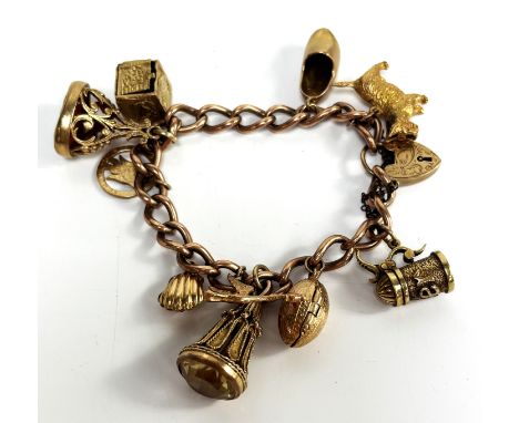 A 9ct gold charm bracelet with collection of charms, most marked 9ct, including a shell cameo and a rugby ball box with small