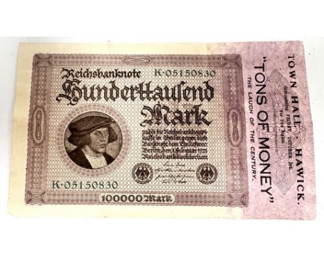A c. 1925 German Reichsbanknote, 100000 Mark, repurposed as a play bill for "Tons of Money". Germany endured hyperinflation d