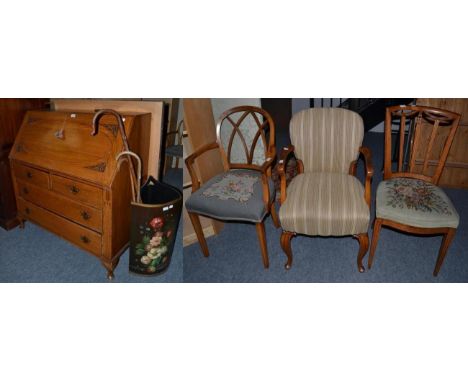 An oak bureau; three chairs; a pine two tier wall rack; a floral decorated stick stand containing three sticks and two modern