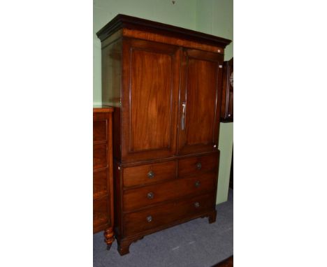 A George III mahogany linen press, enclosing four slide out trays, on bracket feet 