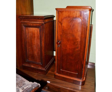 A Victorian mahogany bedside cupboard, circa 1870, with arched recessed cupboard door enclosing a shelf, raised on a platform