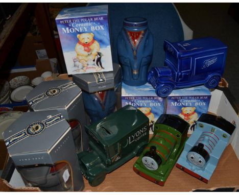 Wade pottery Percy and Thomas the Tank Engine money boxes, three Thornton's Peter money boxes, a Boot's and a Lyon's money bo