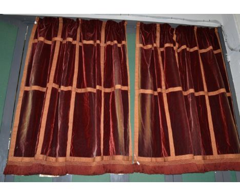 A pair of rust coloured silk velvet curtains with applique ''trellis shape'' trim and fringing 