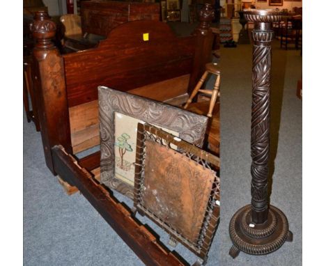 A carved mahogany bedstead, two fire screens, one with a needlework panel, the other tooled leather, together with a 19th cen