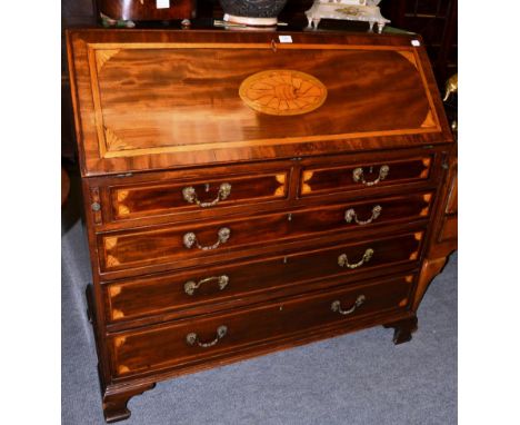 A George III inlaid mahogany bureau on bracket feet, with rococo style handles  