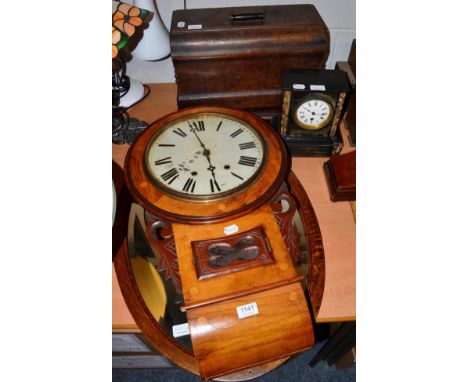 An inlaid drop dial wall clock, oval shaped mirror, a Jones sewing machine, and a black slate mantel timepiece, (4)